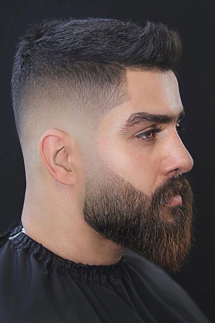 High skin fade with textured crop and sculpted beard