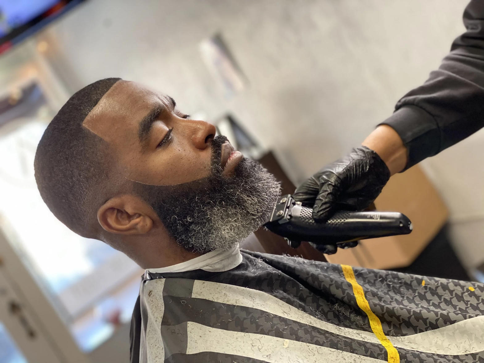 Precision razor hairline edge up with full beard shaping and fade