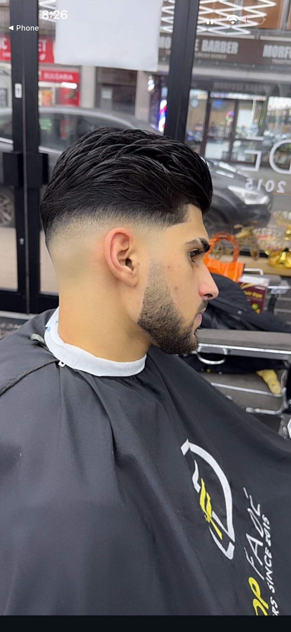 Mid bald fade with slick back textured pompadour flow and tapered beard